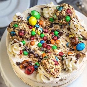 Top view of a round Monster Cookie Icebox Cake on a cake pedestal