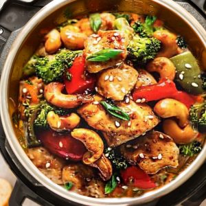 Cashew chicken on a bed of white rice inside of an Instant Pot pressure cooker