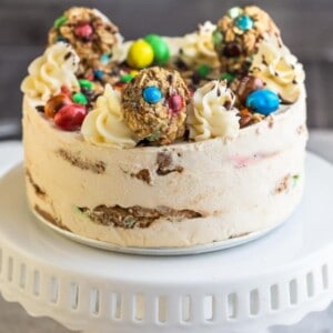 Side view of a whole no bake cookie cake on a white cake stand
