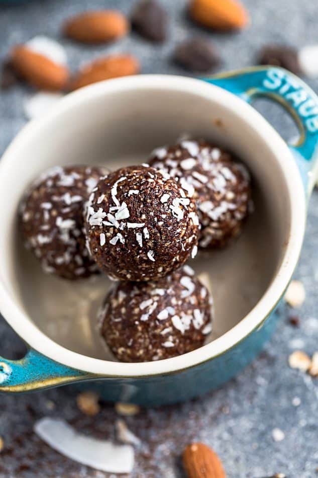 Close-up top view of four chocolate protein balls in a mini blue ramekin