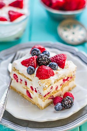 A square of No Bake Summer Berry Icebox Cake on a plate with a fork