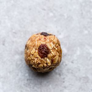 A Single Oatmeal Raisin Energy Ball Sitting on a Countertop