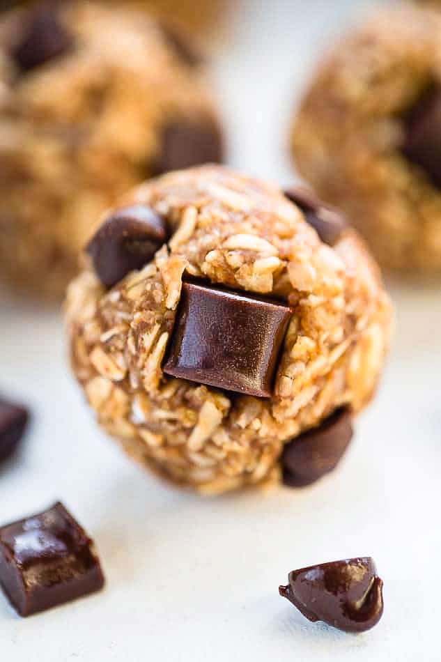 Side shot of one no bake peanut butter energy ball on a white background