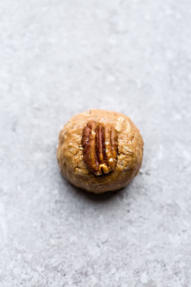 no bake turtle pecan energy ball topped with a whole pecan