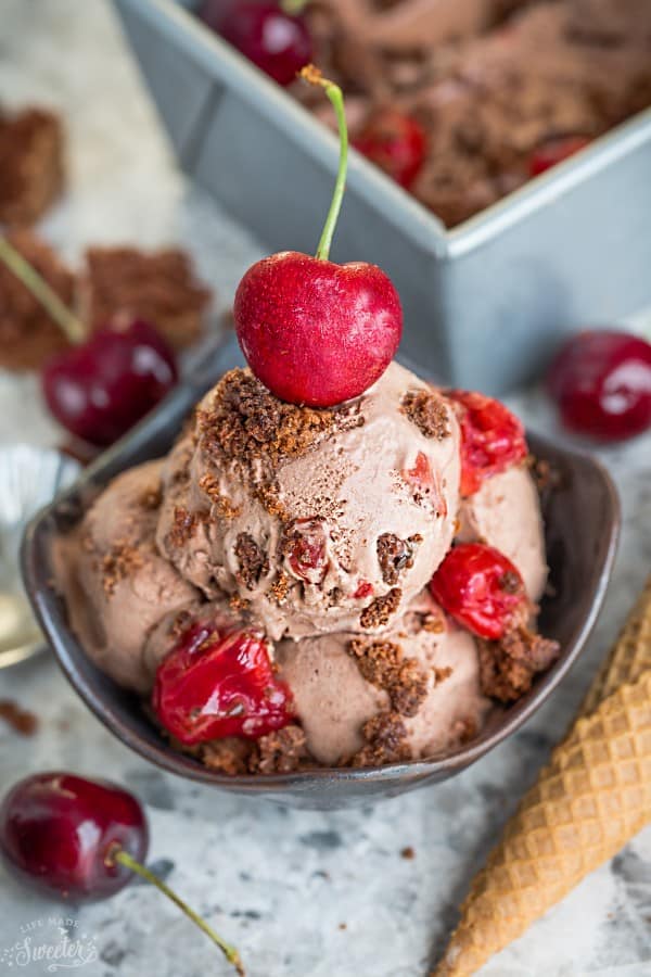 A bowl of No Churn Black Forest Ice Cream topped with a cherry