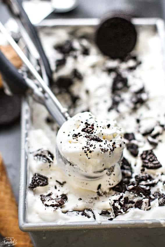 Top view of Cookies and Cream Ice Cream in a loaf pan with an ice cream scoop