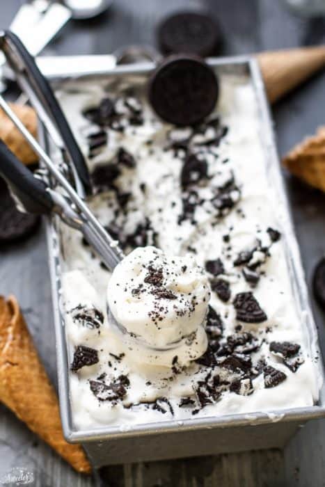 No Churn Oreo Ice Cream in a loaf pan with an ice cream scoop