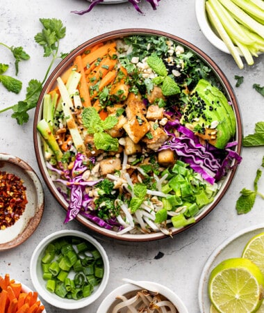 Overhead view of a nourish bowl surrounded by bowls of individual ingredients