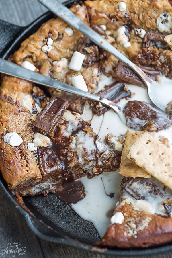 Nutella Stuffed S'mores Skillet Cookie {Pizookie} makes the perfect decadent sweet treat. Full of the classic flavors of a s'mores with an ooey gooey Nutella stuffed filling! Best of all, it's so easy to make with no mixer required!