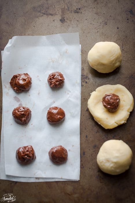 Nutella balls next to peanut butter dough for Nutella Stuffed Peanut Butter Cookies