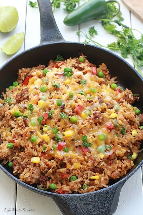 {One Pan} Mexican Rice Skillet - An easy Mexican rice dish made all in one pan in under 30 minutes. Perfect & easiest for weeknights with the best taco flavors. Even the rice made in same pan.