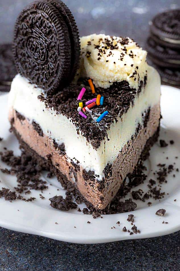 Front view of a slice of Oreo Ice Cream Cake on a white plate