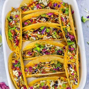 Baked Asian Sesame Chicken Tacos – a simple and delicious recipe perfect for busy weeknights and Cinco de Mayo. Best of all, a short recipe video. Layered with sweet and savory sesame chicken, rainbow vegetables, and a blend of 3 cheeses. Flavor packed and addicting!