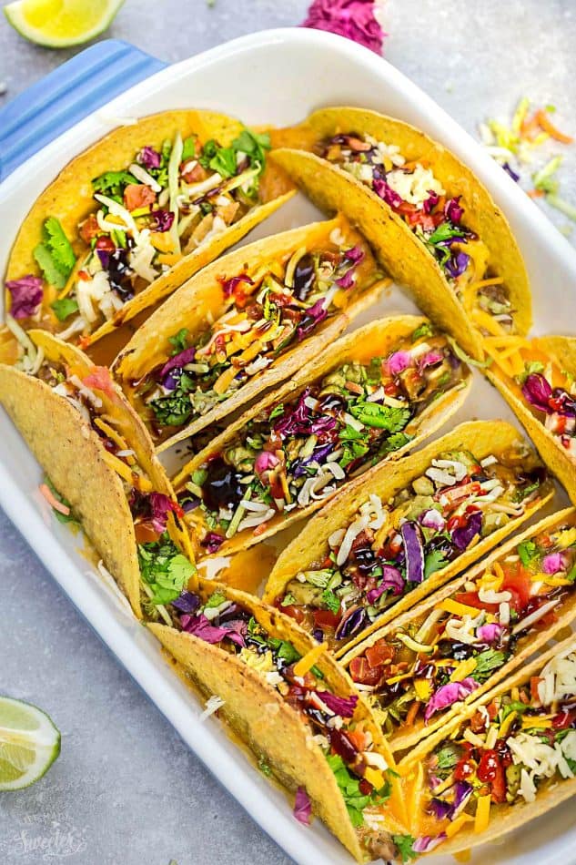 Baked Asian Sesame Chicken Tacos – a simple and delicious recipe perfect for busy weeknights and Cinco de Mayo. Best of all, a short recipe video. Layered with sweet and savory sesame chicken, rainbow vegetables, and a blend of 3 cheeses. Flavor packed and addicting!