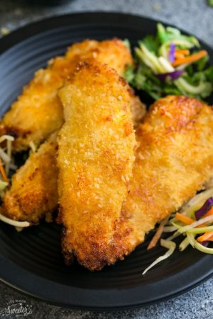 Oven Baked Fried Chicken pieces with rainbow slaw on a plate