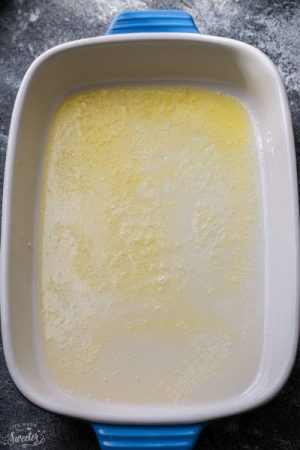Overhead view of melted butter in a baking dish
