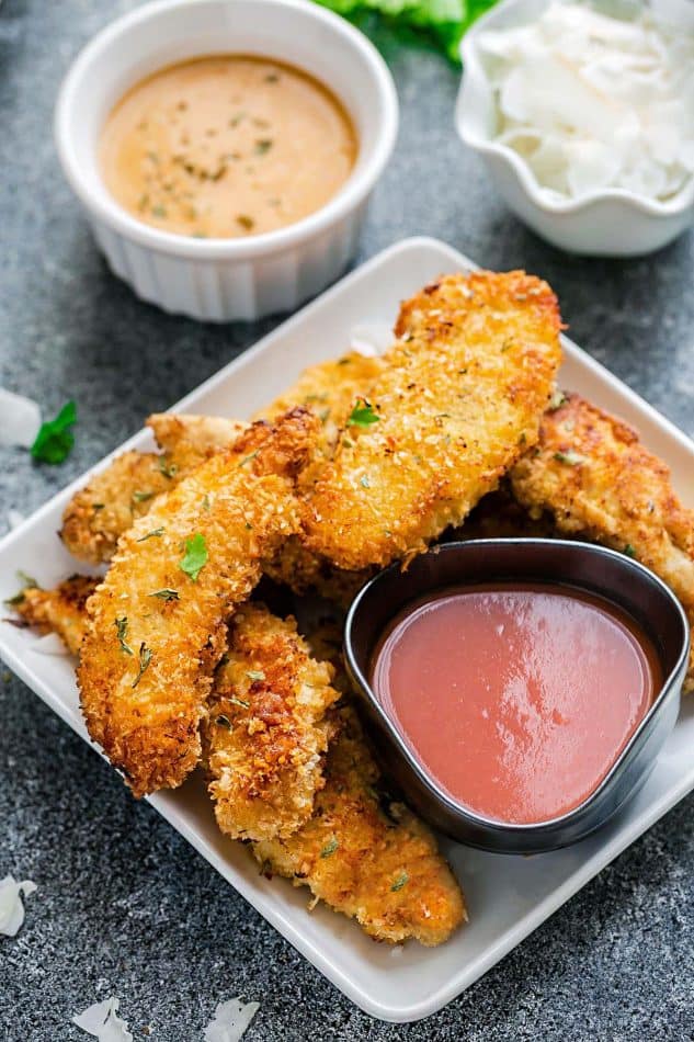 plate of oven fried chicken on a plate with bbq dipping sauce