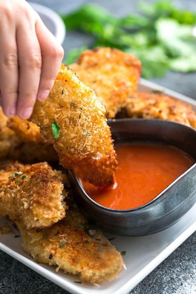 Oven Baked Fried Chicken Tenders and a side of spicy buffalo sauce