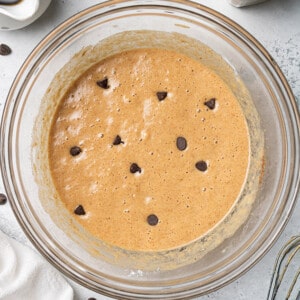 Chocolate chip pancake batter in a clear mixing bowl