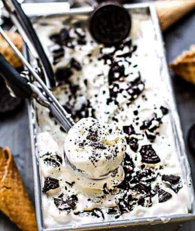 Top view of Cookies and Cream Ice Cream in a loaf pan with an ice cream scoop