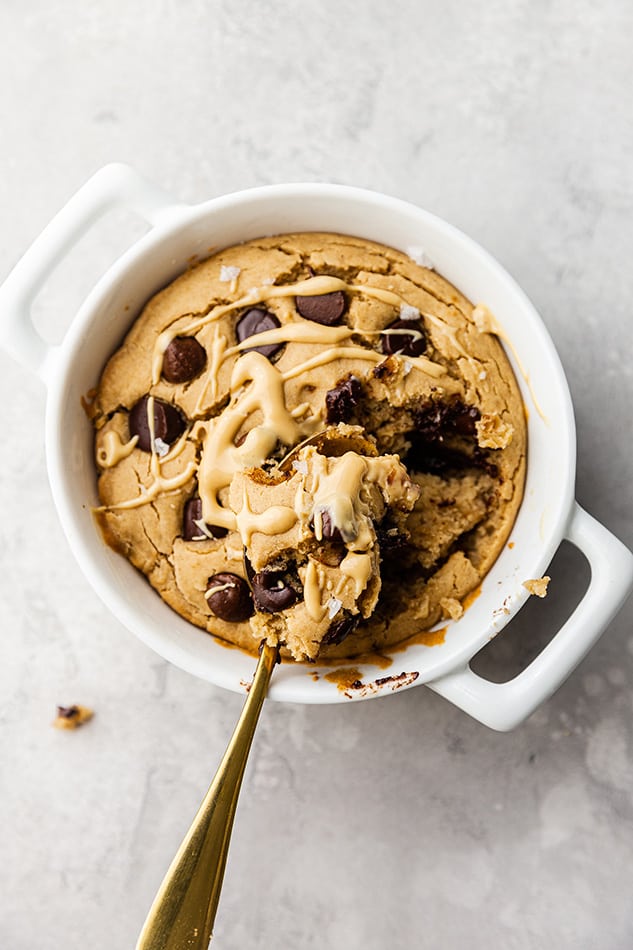 A Spoon Digging Into a Round Pan Full of Grain-Free Chocolate Chip Baked Oats