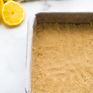 Almond flour crust in a square metal baking pan