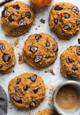 Close-up top view of 6 low carb keto pumpkin cookies on a grey background