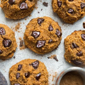 Close-up top view of 6 low carb keto pumpkin cookies on a grey background