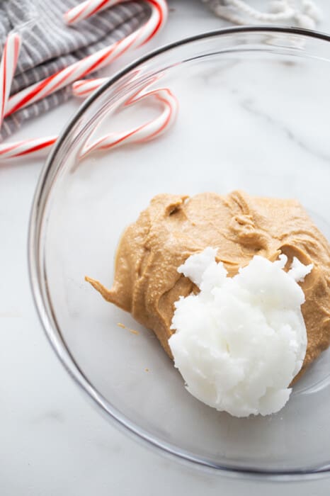 Top view of cashew butter and coconut oil in a clear white bowl