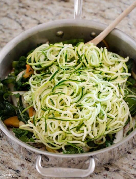 Top view of spiralized zucchini for Low Carb Noodles in a stainless-steel pan