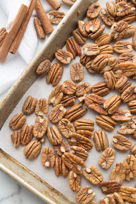 Top view of raw pecans on a baking sheet