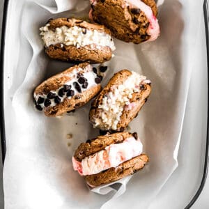 Top view of four vegan ice cream sandwiches in a white pan lined with parchment paper
