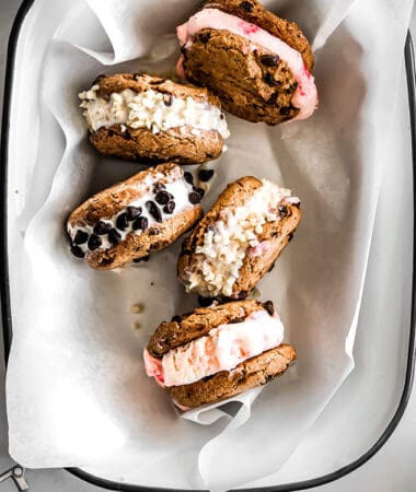 Top view of four vegan ice cream sandwiches in a white pan lined with parchment paper