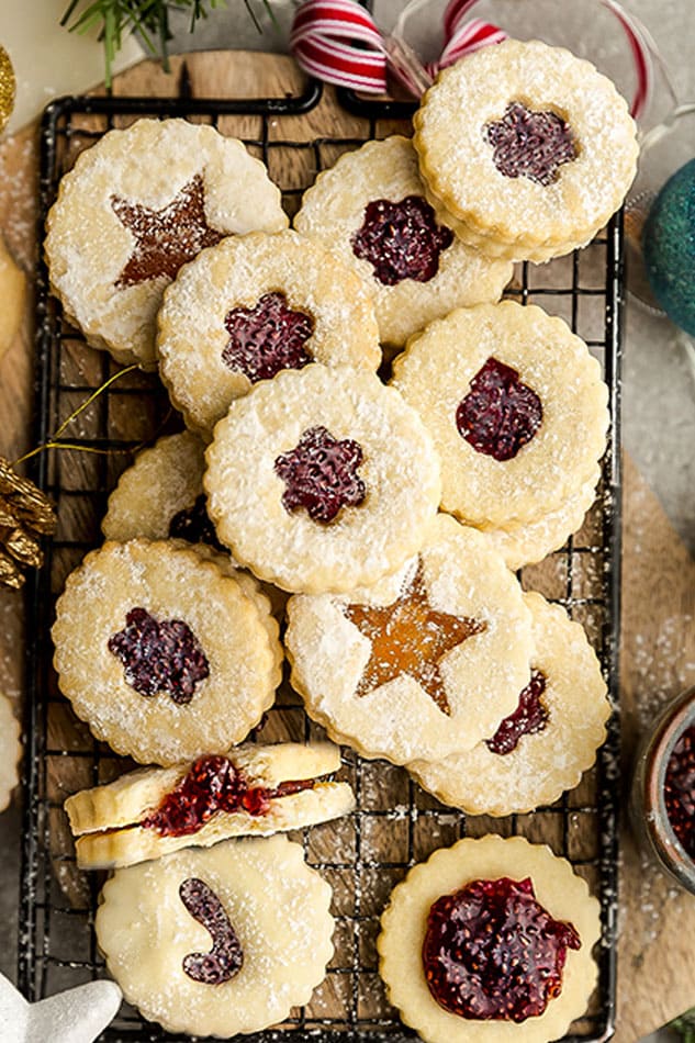 Close-up top view of a pile of keto linzer cookies on a wire rack