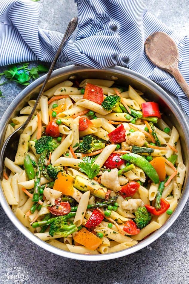 This Pasta Primavera recipe comes together in under 30 minutes so it's perfect for busy weeknights. Best of all, it's chock full of fresh lemon, asparagus, snap peas, carrots and cherry tomatoes.