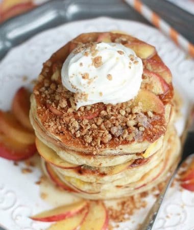 Peach Cobbler Pancakes - extra fluffy pancakes filled with juicy peaches topped with a warm spiced streusel is like having a yummy peach cobbler for breakfast