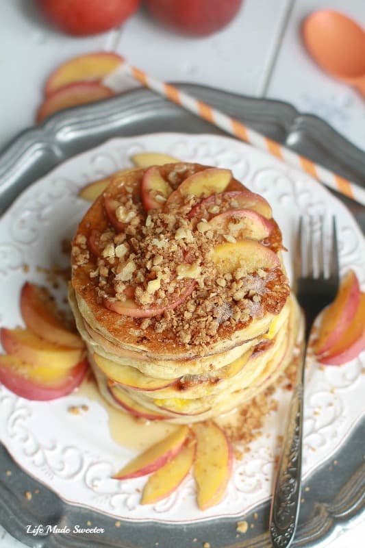 Peach Cobbler Pancakes - fluffy pancakes filled with juicy peaches topped with a warm spiced streusel is like having dessert for breakfast