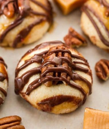 Pecan Turtle Shortbread Thumbprint Cookies make the perfect holiday treat for your Christmas cookie platter. Best of all, they're so easy to make and are full of creamy caramel, chocolate and a crunchy pecan center.