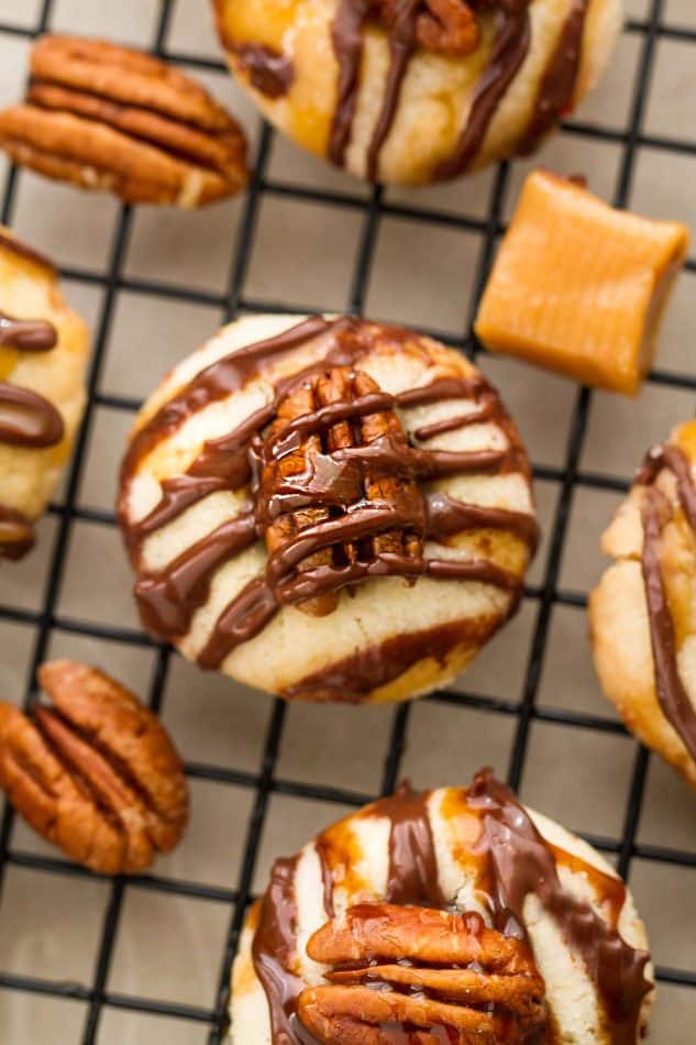 Pecan Turtle Shortbread Thumbprint Cookies make the perfect holiday treat for your Christmas cookie platter. Best of all, they're so easy to make and are full of creamy caramel, chocolate and a crunchy pecan center.