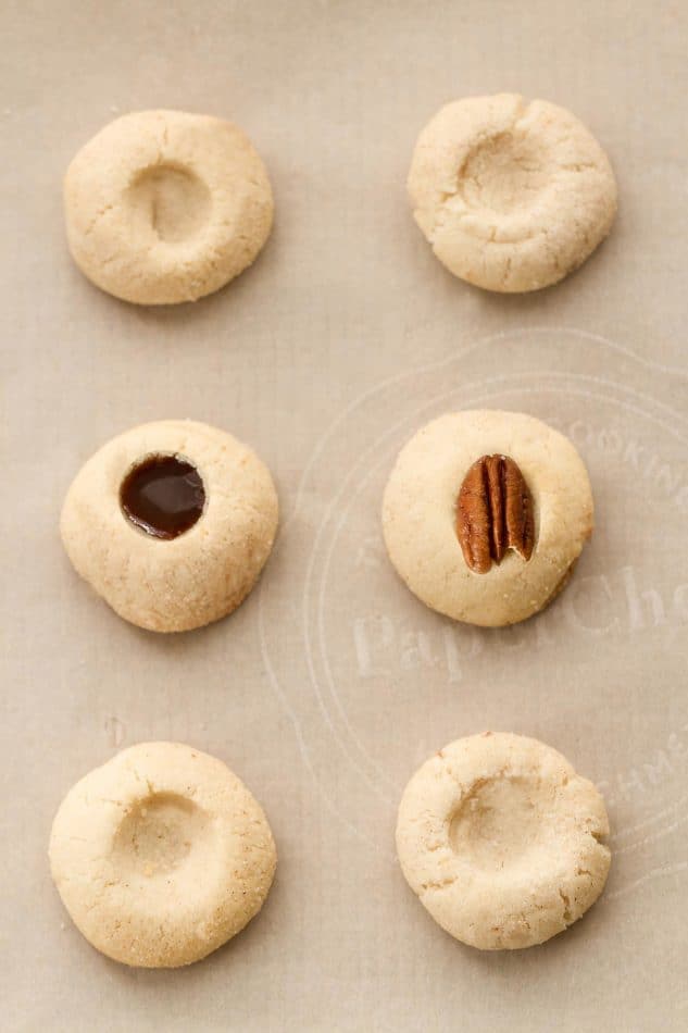 Pecan Turtle Shortbread Thumbprint Cookies make the perfect holiday treat for your Christmas cookie platter. Best of all, they're so easy to make and are full of creamy caramel, chocolate and a crunchy pecan center.