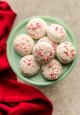 Peppermint Covered Oreos are the perfect festive and easy treat for the holidays. Vanilla or chocolate Oreo cookies are coated in white chocolate candy melts and crushed candy canes.
