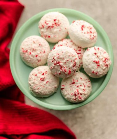 Peppermint Covered Oreos are the perfect festive and easy treat for the holidays. Vanilla or chocolate Oreo cookies are coated in white chocolate candy melts and crushed candy canes.