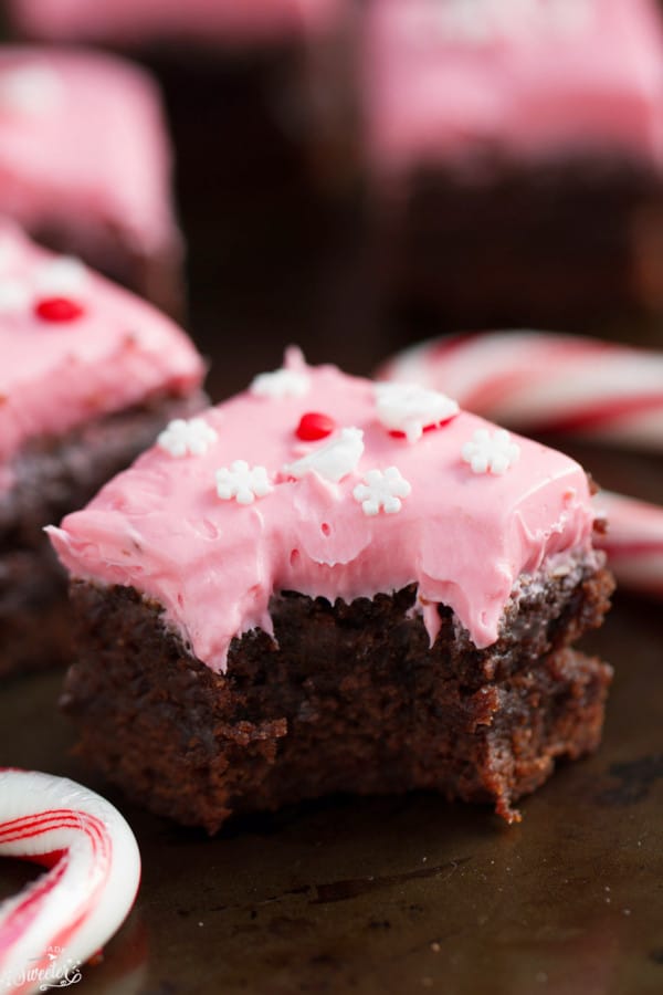 Close-up of a pink frosted peppermint brownie with a bite removed