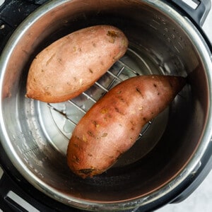 Top view of two raw sweet potatoes in an Instant Pot