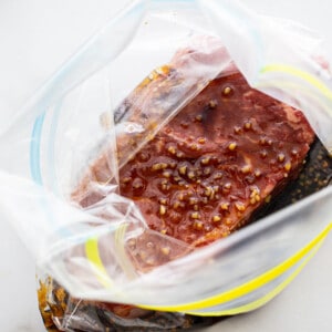 Top view of one marinated sirloin steak in ziplock bags