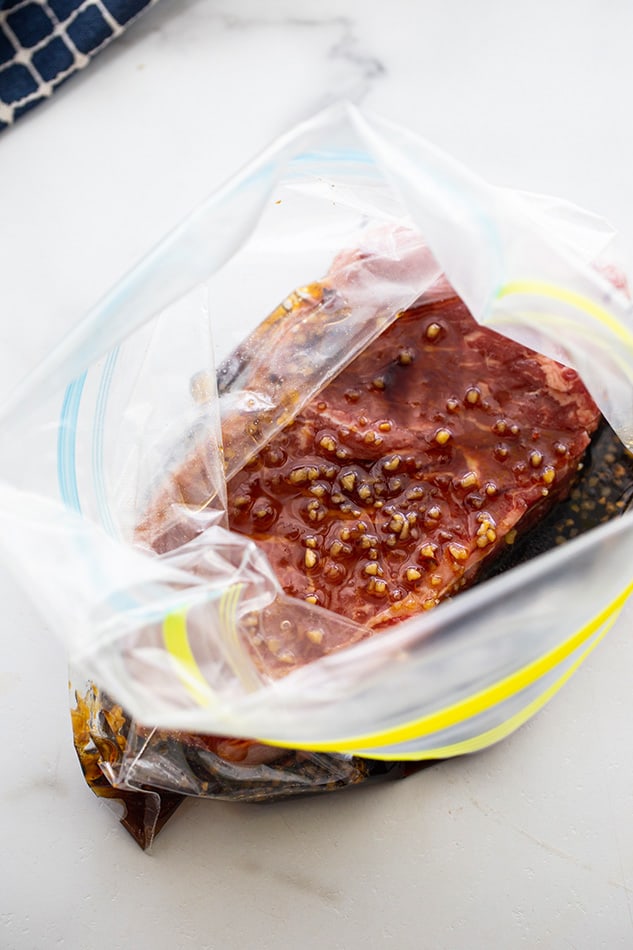 Top view of one marinated sirloin steak in ziplock bags