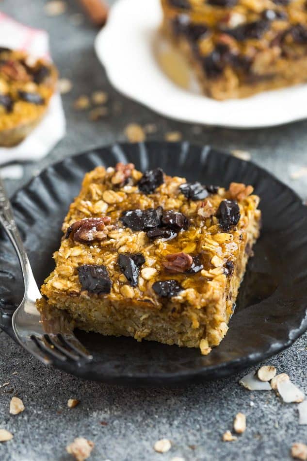 Pumpkin Baked Oatmeal with Chocolate and Pecans - the perfect easy make-ahead breakfast or brunch for fall! Best of all, you can bake them into muffin tins for grab and go oatmeal cups or take them along to work or school. They're full of cozy warm flavors and come together easily in just one bowl using healthy and wholesome ingredients. Gluten free & refined sugar free.