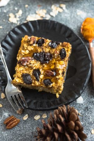 Pumpkin Baked Oatmeal with Chocolate and Pecans - the perfect easy make-ahead breakfast or brunch for fall! Best of all, you can bake them into muffin tins for grab and go oatmeal cups or take them along to work or school. They're full of cozy warm flavors and come together easily in just one bowl using healthy and wholesome ingredients. Gluten free & refined sugar free.