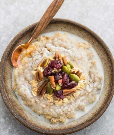 Pumpkin Steel Cut Oats - the perfect healthy make-ahead breakfast for fall. Made with gluten free oats, cozy fall spices, pumpkin puree, dried cranberries & pepitas. Best of all, includes instructions for the Instant Pot pressure cooker & the stove.
