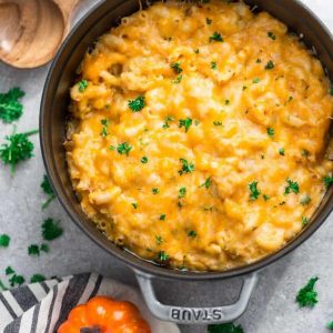 This recipe for Easy Pumpkin Stovetop Macaroni & Cheese takes only 30 minutes to make for a perfect weeknight meal for fall. Best of all, it's super creamy and made with a mix of three popular cheeses: sharp cheddar, parmesan and cream cheese. It's the ultimate fall comfort food and makes the perfect side dish for Thanksgiving or the Christmas holiday feast! #lunch #dinner #comfortfood #pumpkin #macandcheese #macaroniandcheese